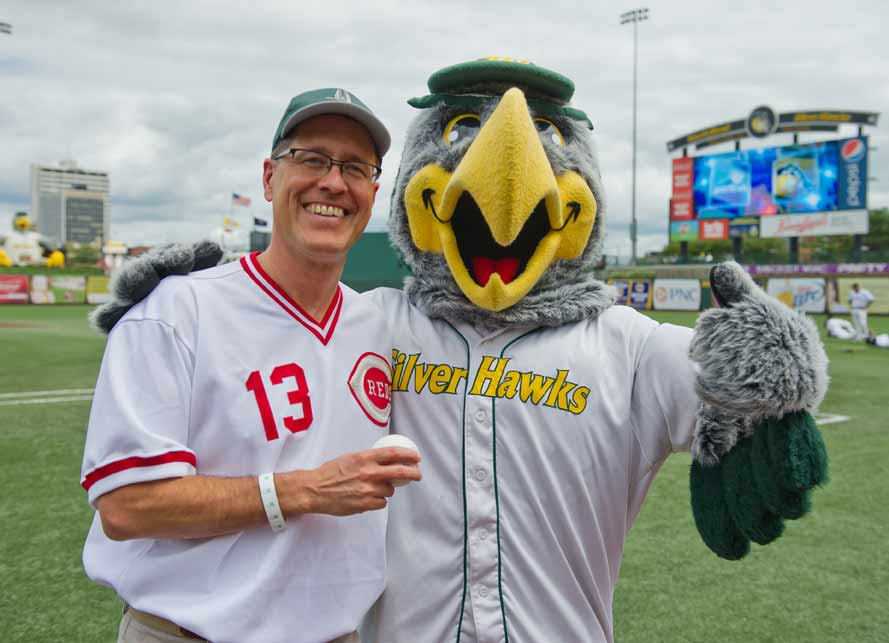 Jul. 29, 2013; Center for Social Concerns Director Rev. Paul Kollman poses with South Bend Silverhawks mascot Swoop after throwing out the ceremonial first pitch at a game at Coveleski Stadium. Photo by Matt Cashore/University of Notre Dame(click on image to purchase)