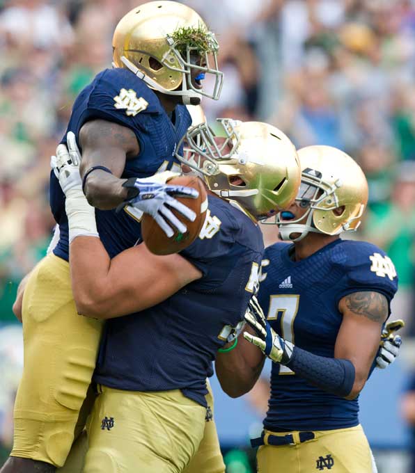 Aug. 31, 2013; Notre Dame wide receiver DaVaris Daniels celebrates his touchdown with teammates during the first quarter against Temple. Photo by Barbara Johnston/University of Notre Dame