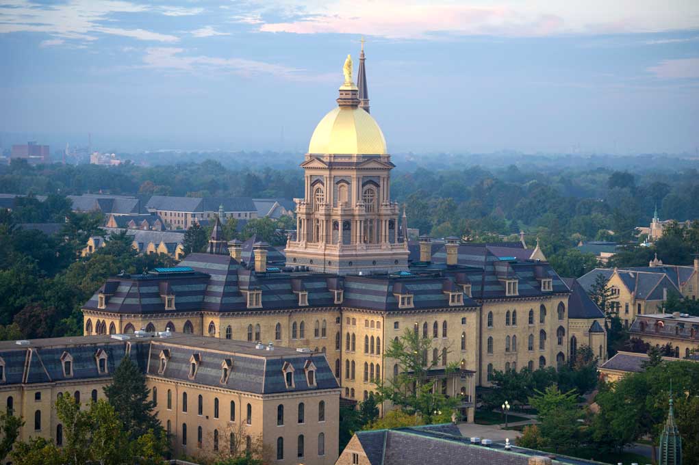 Sept. 24, 2013; The statue of Mary atop the Golden Dome of the Main Building at sunrise. Photo by Barbara Johnston/University of Notre Dame