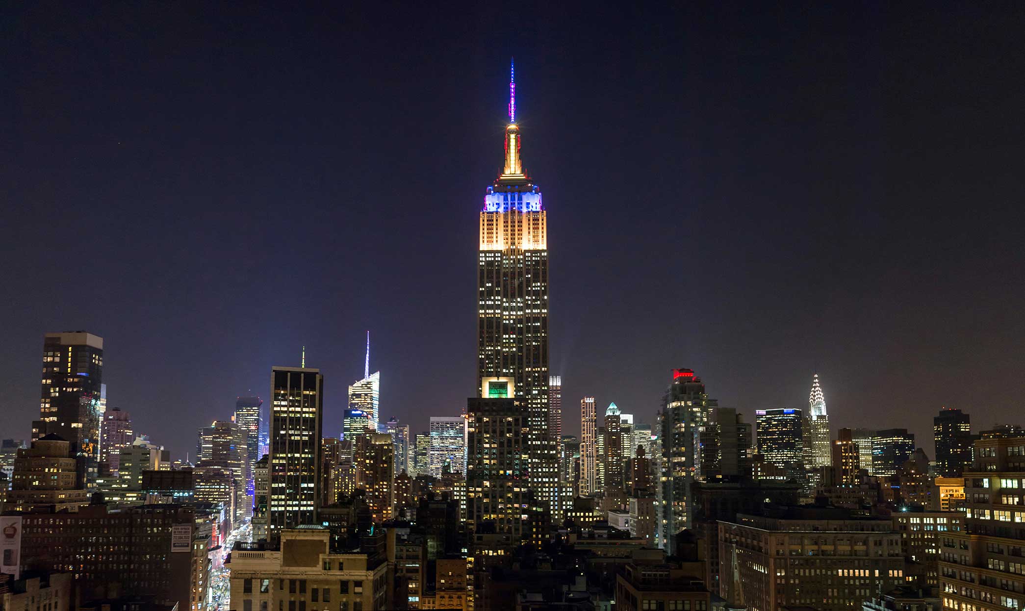 Dec. 27, 2013; The Empire State Building in New York City is lit with blue and gold lighting to mark the 2013 Pinstripe Bowl game between Notre Dame and Rutgers. Photo by Matt Cashore 