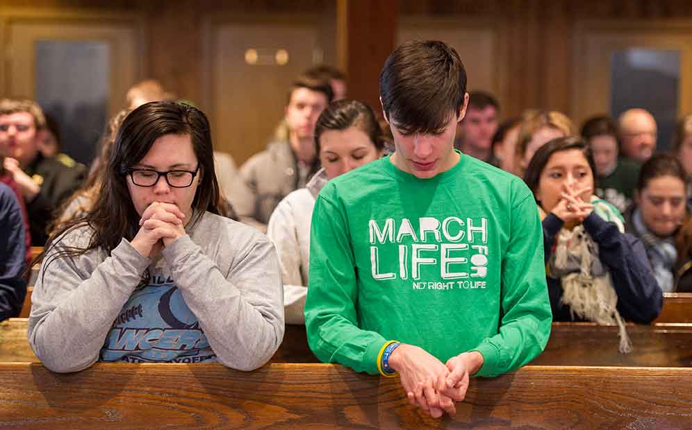 Jan. 22, 2014; Students pray during Mass at St. Agnes Church in Arlington, Virginia before the 2014 March for Life. Photo by Barbara Johnston/University of Notre Dame