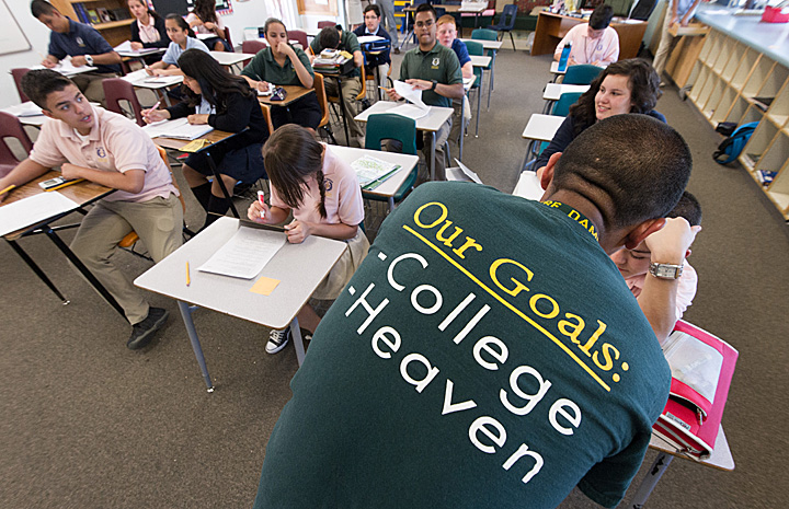 ACE teacher Matthew Gring wears a t-shirt proudly displaying the ACE Academy goals: College and Heaven, as he teaches his class at St. Ambrose School in Tucson, AZ.