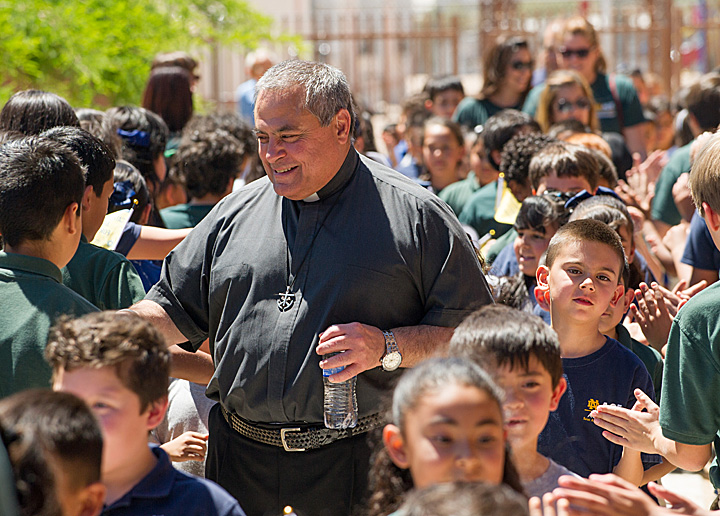 Fr. Joe Corpora, C.S.C. greets students at St. Ambrose Catholic School in Tucson, Arizona, an ACE Academy.
