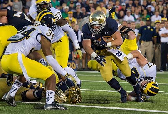 Cam McDaniel tosses Michgan defenders aside on his way to ND's first score.