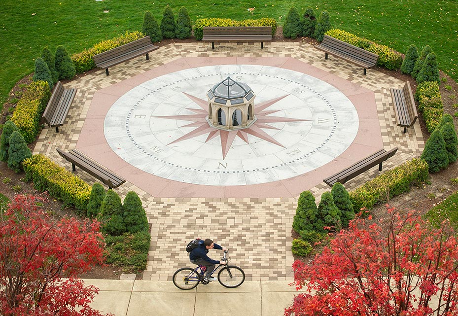 Oct. 28, 2014; A student rides past the main entrance of Jordan Hall of Science. (Photo by Barbara Johnston/University of Notre Dame)