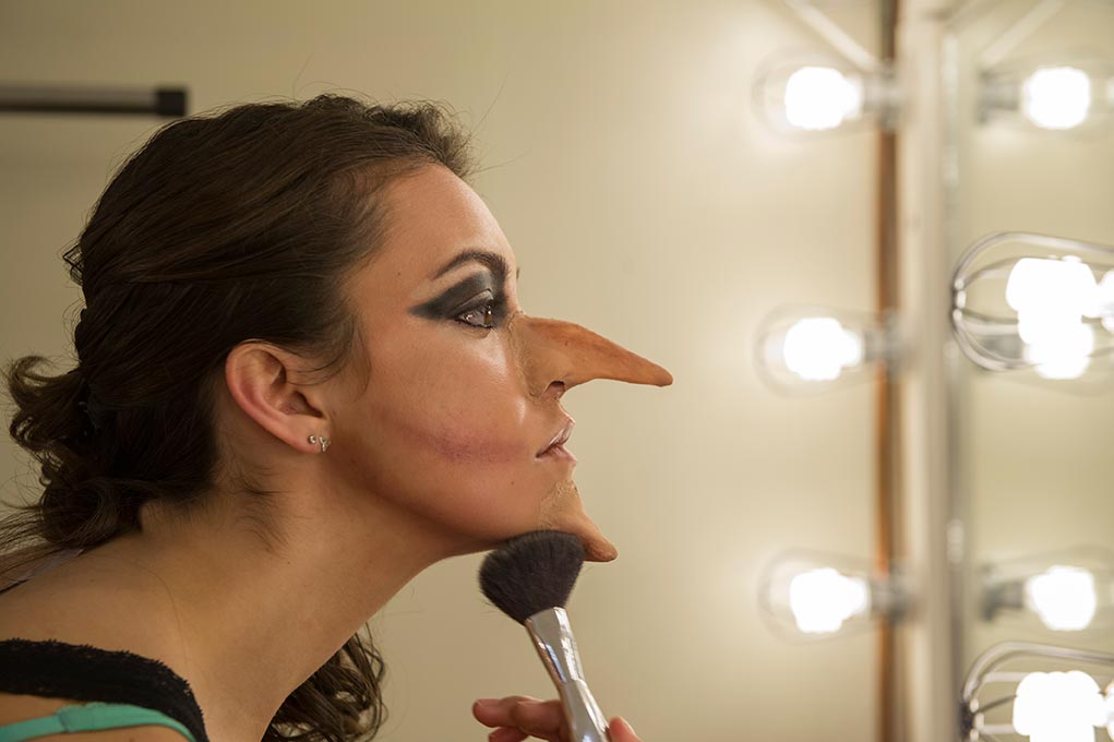 Nov. 10, 2014; Elizabeth Curtin puts on her makeup for her character, the Witch before dress rehearsal for "Into the Woods." (Photo by Barbara Johnston/University of Notre Dame)