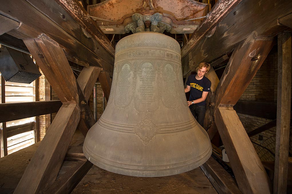 Sept. 8, 2014; Graduate student Benjamin Sunderlin examines the carillon church bells in the bell tower of the Basilica of the Sacred Heart. (Photo by Barbara Johnston/University of Notre Dame)