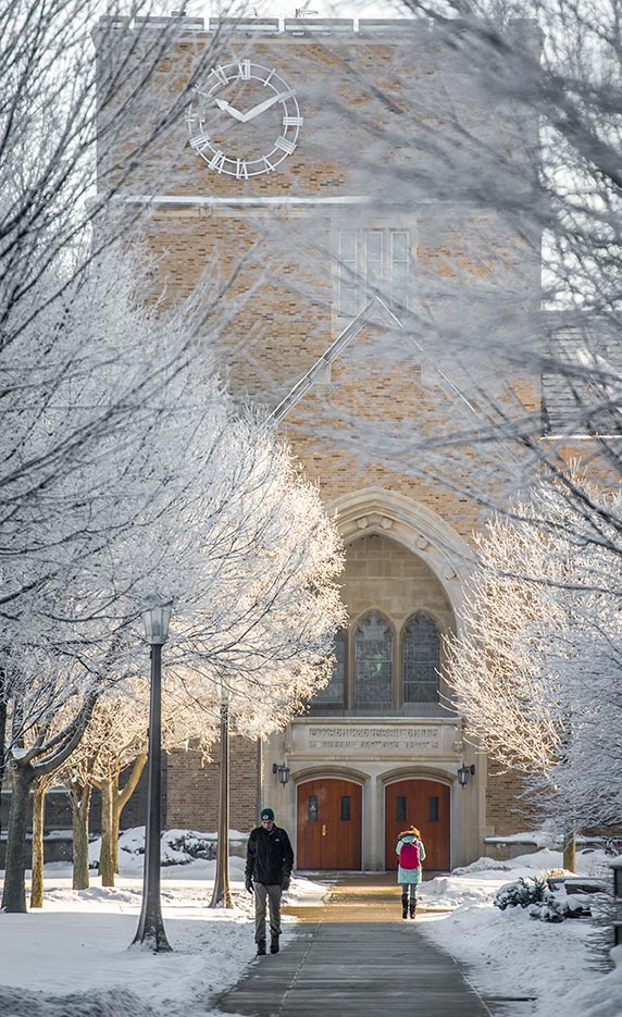Jan. 14, 2015; Students brave the bitter cold (5 degrees) as they walk to class. Frost covers the trees in front of O'Saughneesy Hall. (Photo by Barbara Johnston/University of Notre Dame)