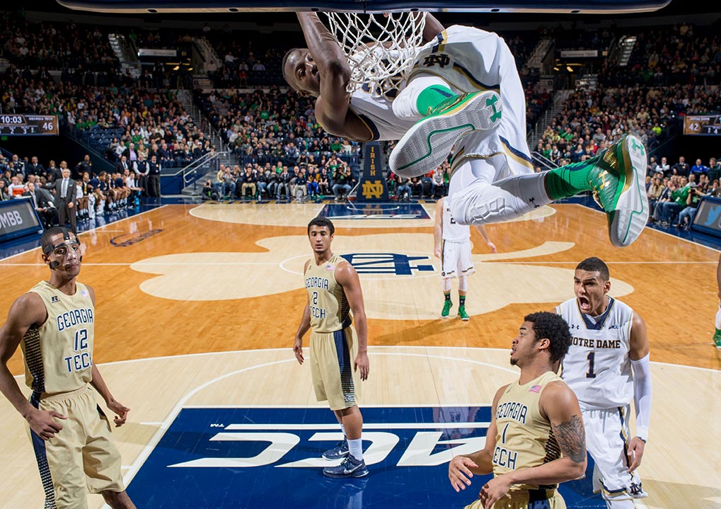 Jan 3, 2015; Jerian Grant (22) hangs on the rim after a dunk in the second half against the Georgia Tech Yellow Jackets at the Purcell Pavilion. Notre Dame won 83-76 in double overtime. (Photo by Matt Cashore)
