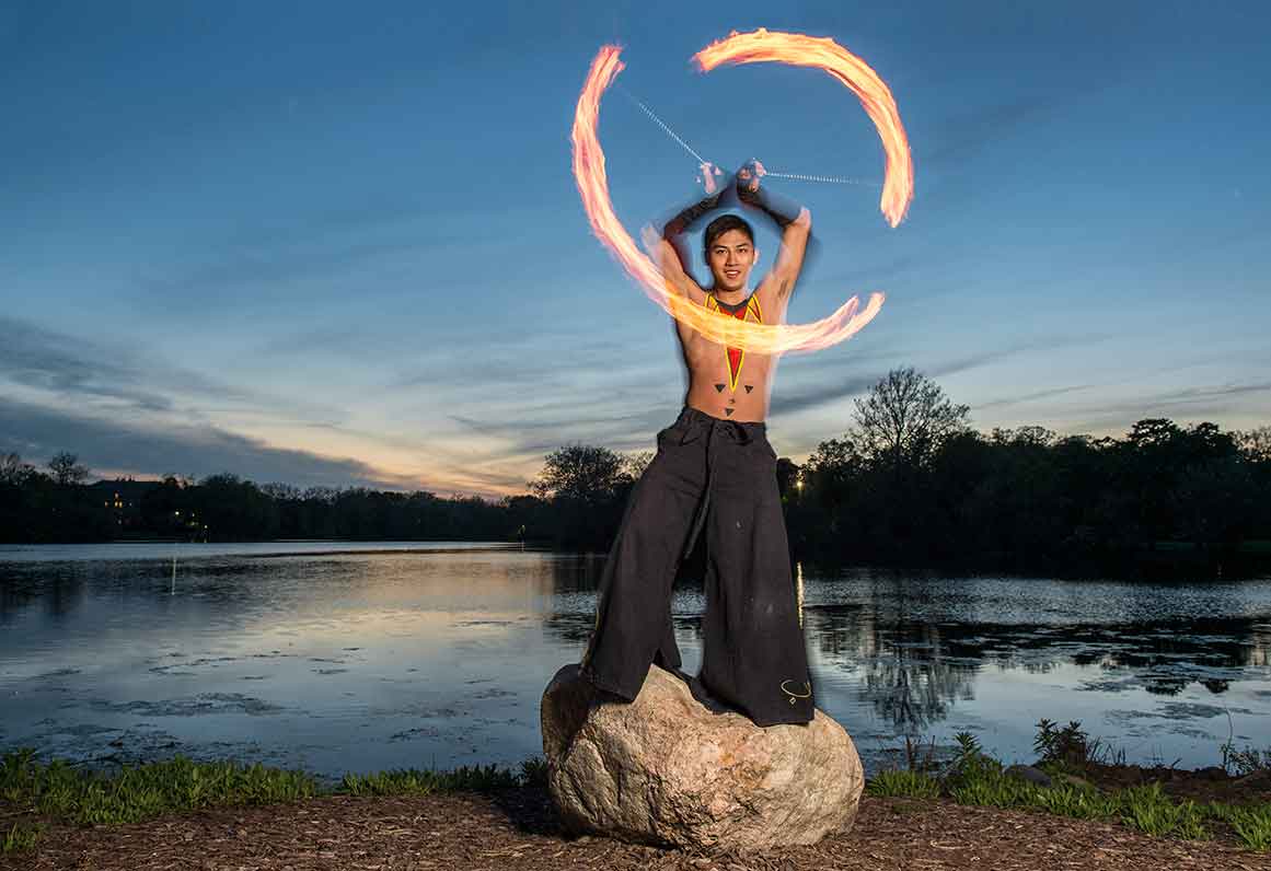 May 13, 2015; Senior Mark O'Dea demonstrates his fire dancing skills on the shore of St. Mary's Lake. (Photo by Barbara Johnston/University of Notre Dame)