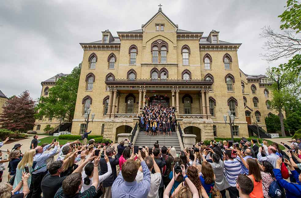 May 17, 2015; Graduates toss their caps in the air on the steps of the Main Building as family and friends gather to capture the moment. (Photo by Barbara Johnston/University of Notre Dame)