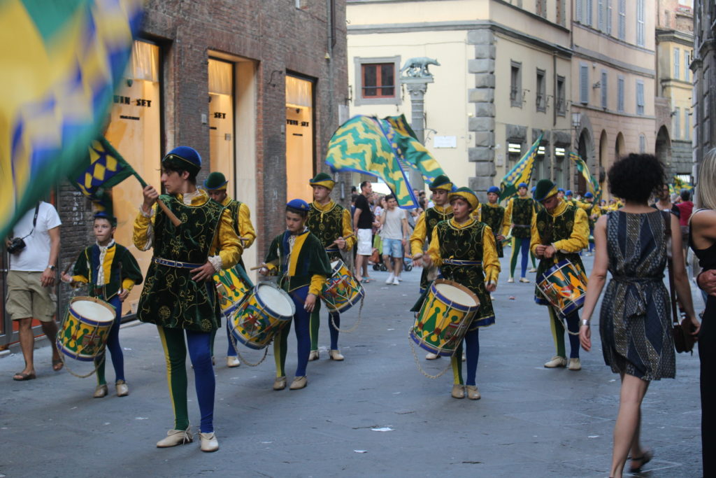 A parade of young people from the contrada Bruco