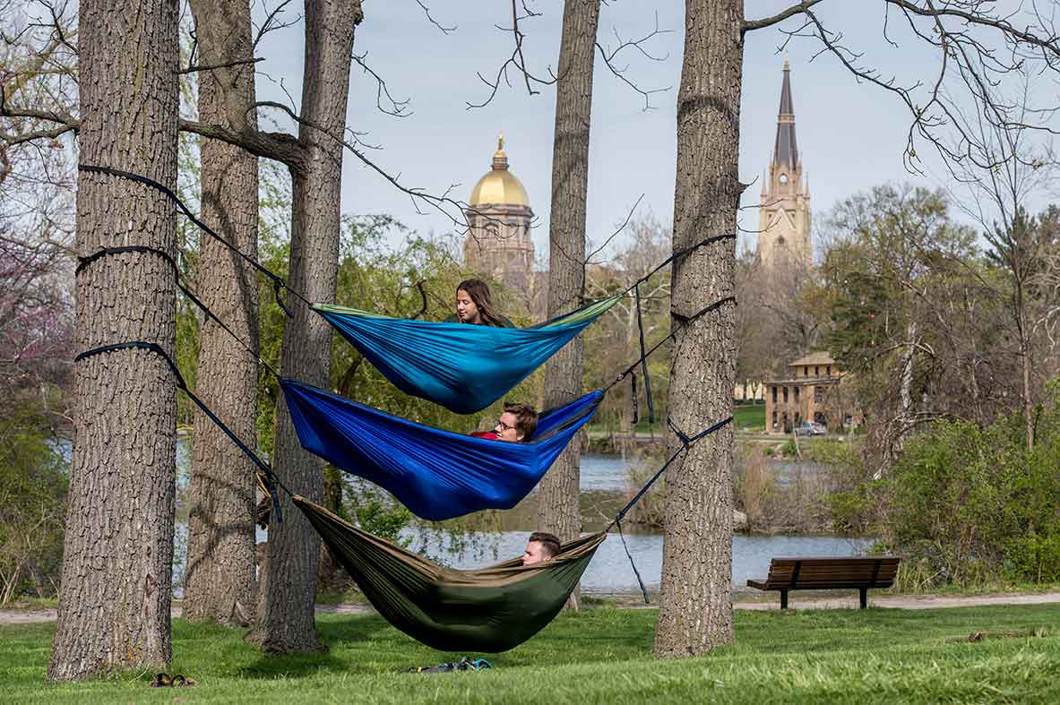 April 29, 2015; Students relax in their hammocks near St. Mary Lake. (Photo by Barbara Johnston/University of Notre Dame)